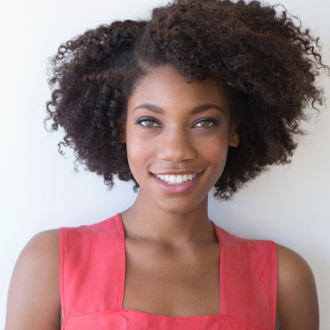 Portrait of young woman against white background